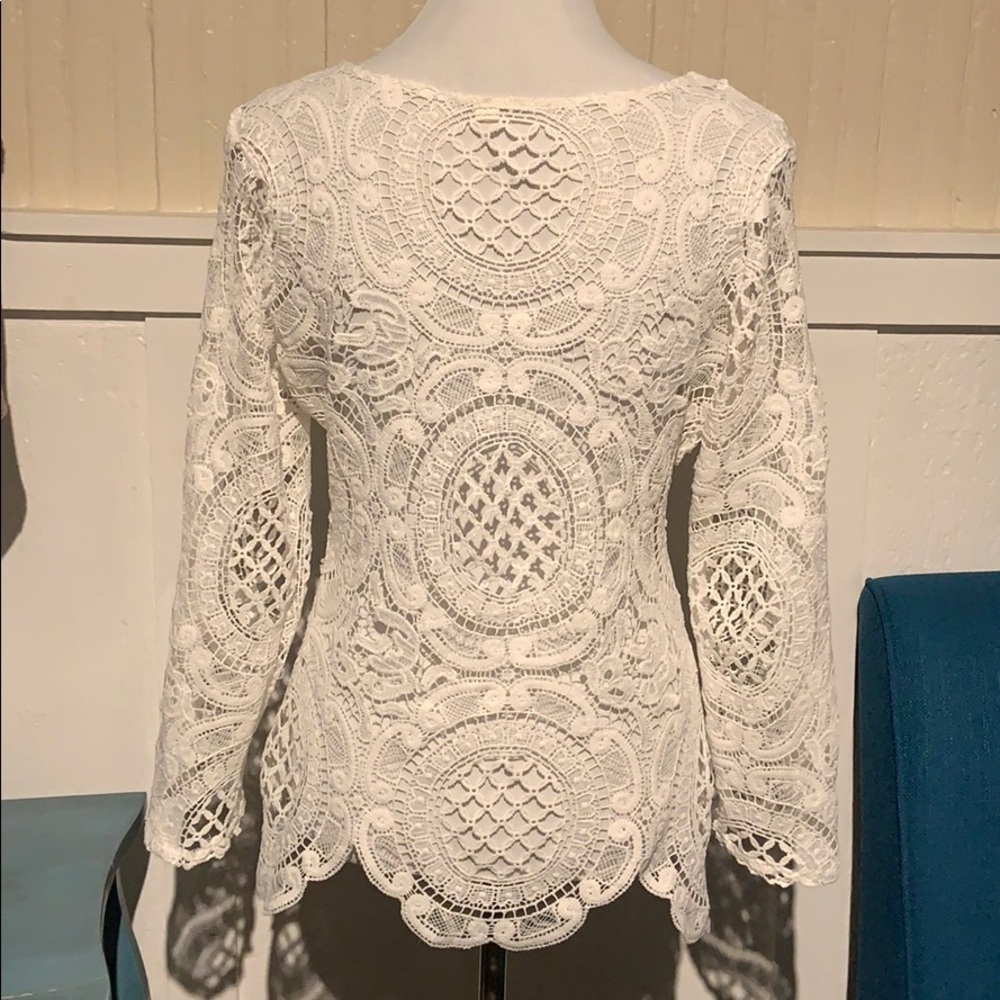 Long sleeved lace top with tank top underneath.